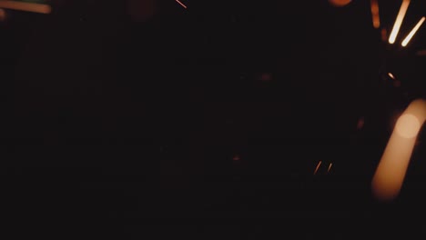 4k resolution of burning firework bright sparks on black background, Christmas and New year spirit. In and out of focus