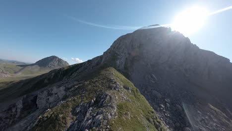 sun over rocky mountains of spain, aerial fpv view