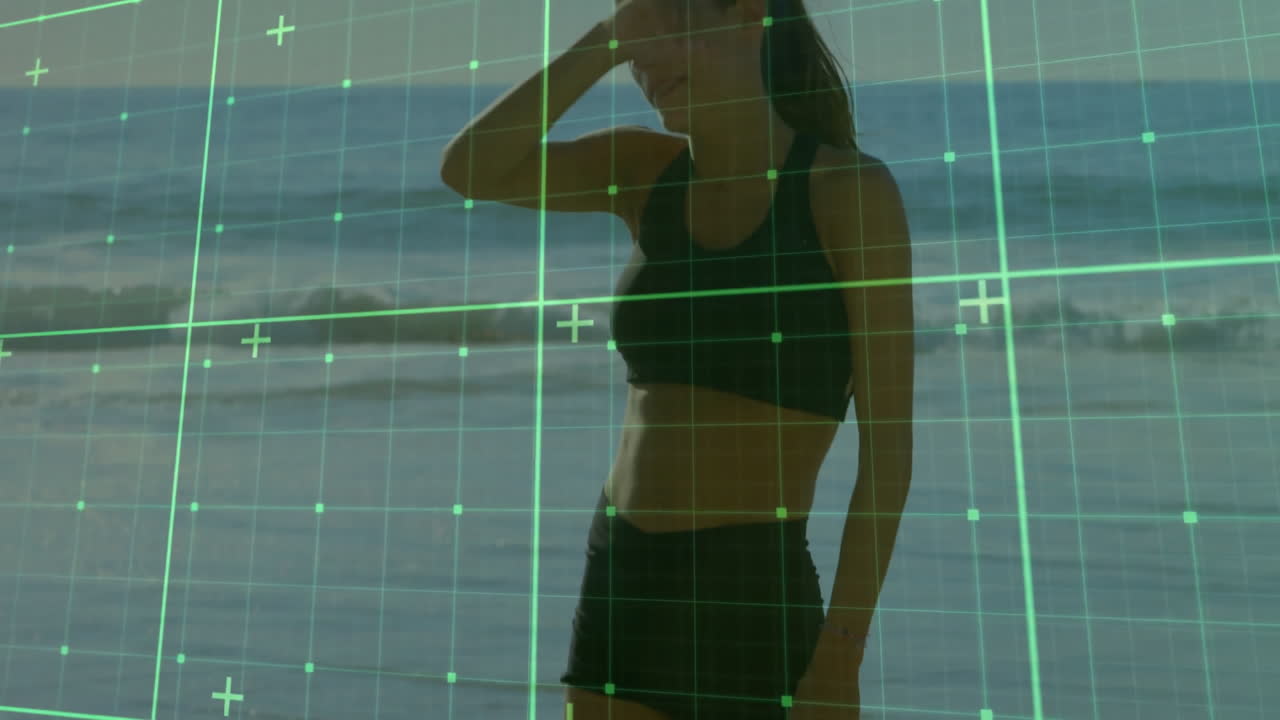 Woman in athletic wear on beach with digital grid overlay animation