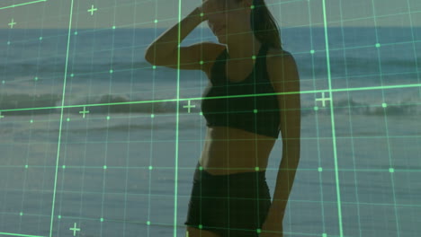 woman in athletic wear on beach with digital grid overlay animation