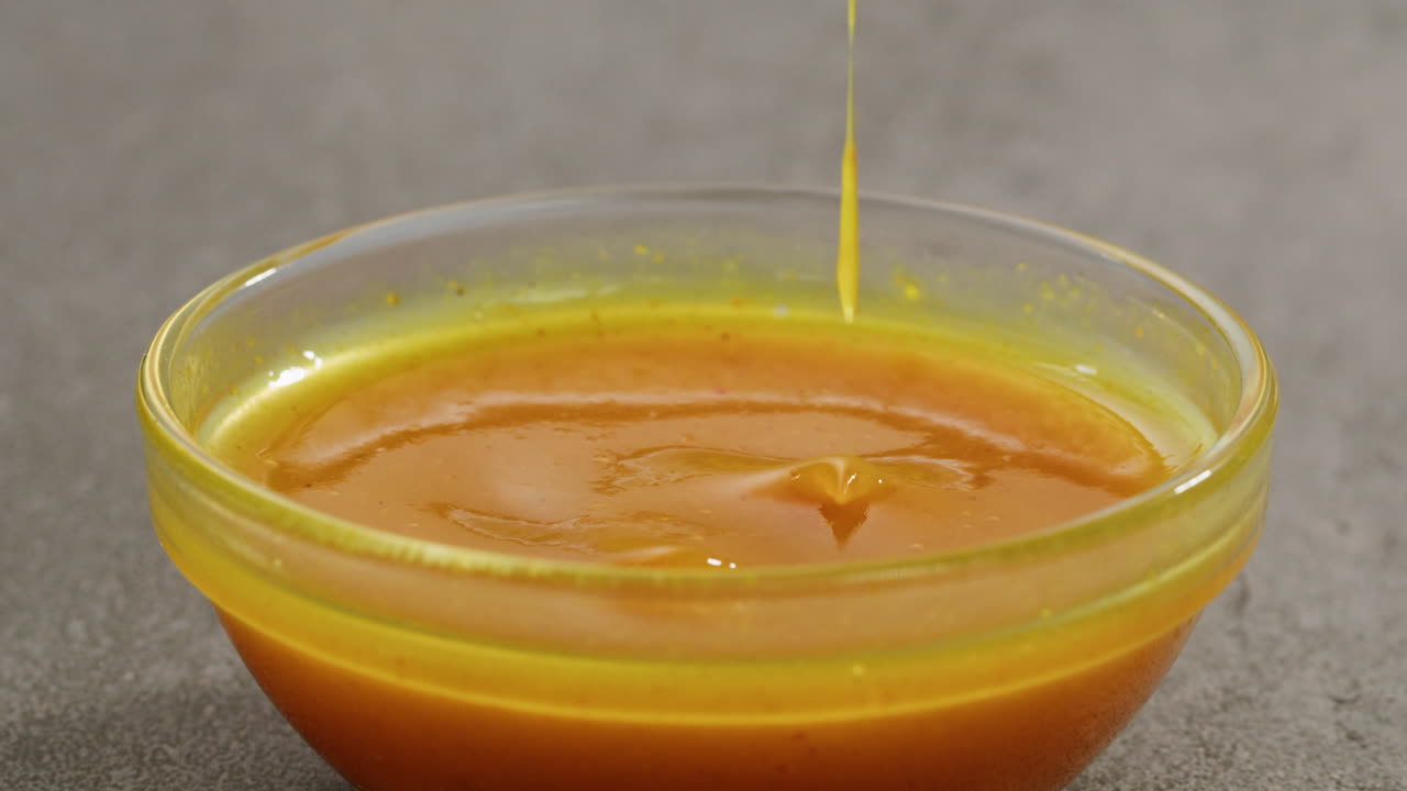 Curry cheese lemon sauce close up, fast food cafe Pouring fries potato and fry chicken in mayo yellow creamy cheese sauce close-up. Eat chicken nuggets with Peruvian sauce. Fast and junk food concept.