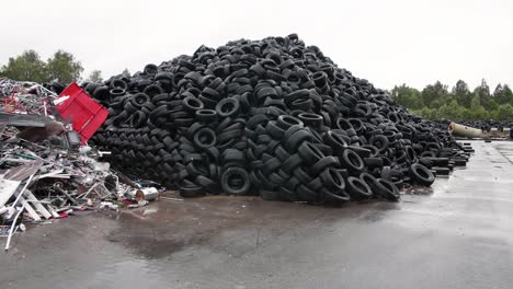 massive pile of used tires in a recycling facility