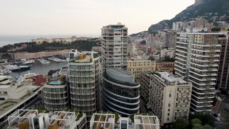 Skyscraper-High-Rise-Buildings-in-Downtown-Monaco-City,-Rising-Aerial-Drone-Reveal