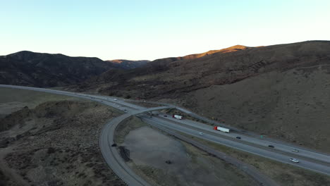 cars and trucks travel on the grapevine pass connecting los angeles county and the central california valley