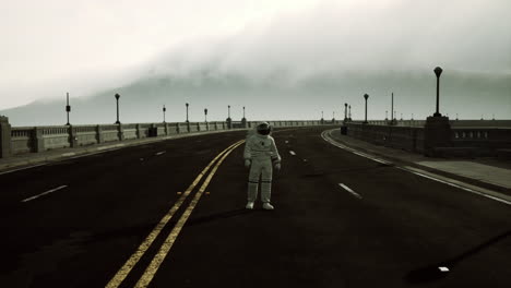 astronaut-walks-in-the-middle-of-a-road