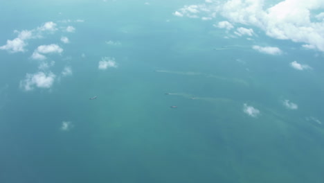 Airplane-Window-View-Of-Plane-Flying-From-Australia-To-Singapore---Flying-Above-Earth-Landscape-And-Clouds---POV