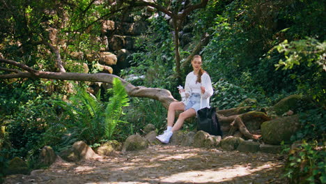girl tourist drink water sitting beautiful forest. woman quenching thirst nature
