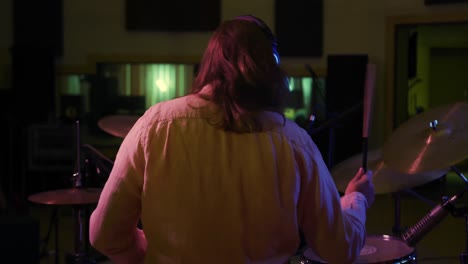 Man-playing-drums-in-a-music-studio