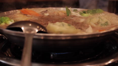 kimchi stew boiling and bubbling in pot in seoul south korea