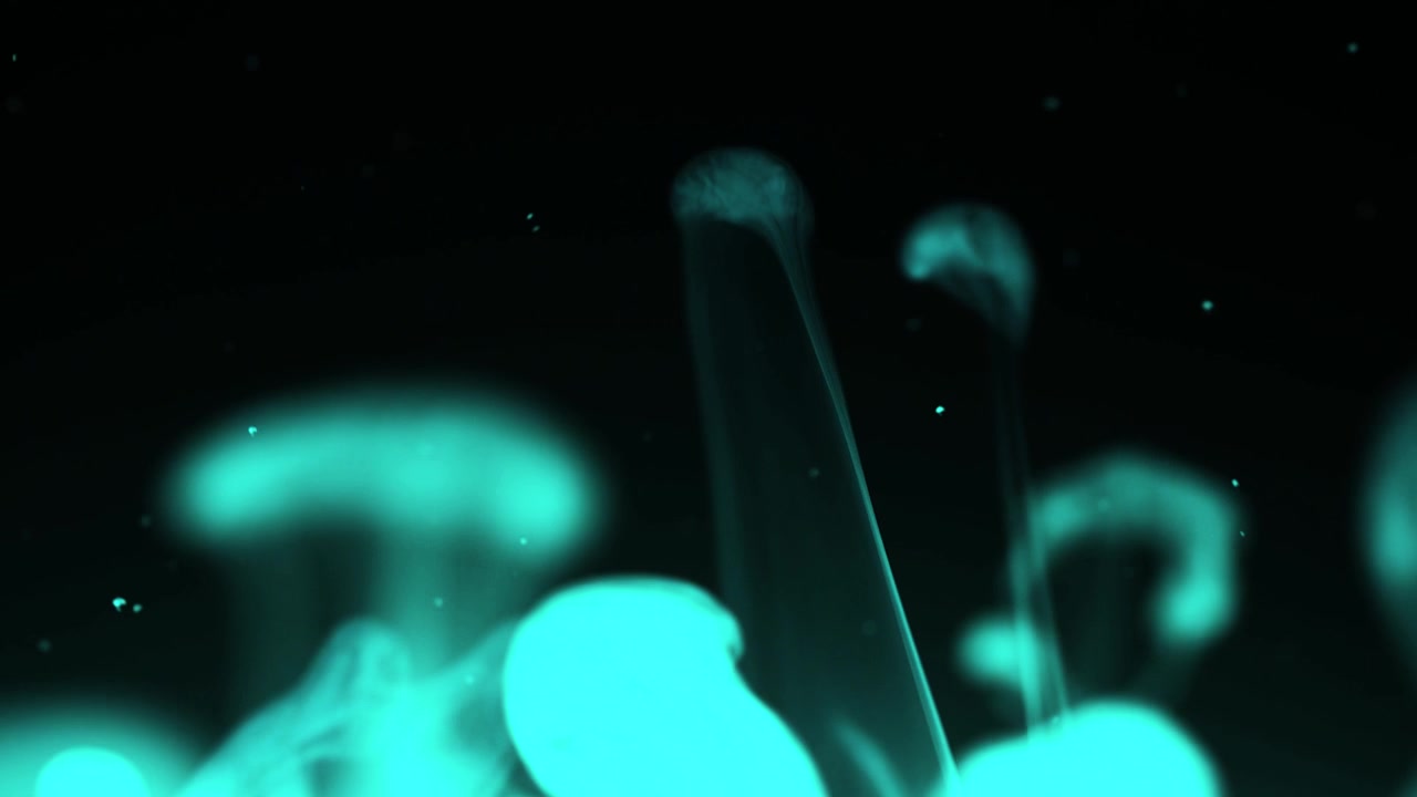 Elegant Wisps of Blue Smoke and Particles Against Black Background