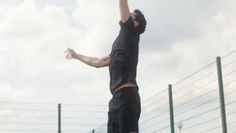 Lower-view-of-brunet-man-hitting-a-volleyball