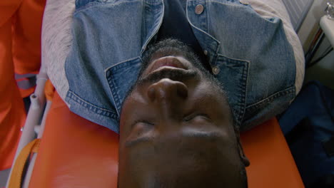 top view of a patient lying on a stretcher inside an ambulance