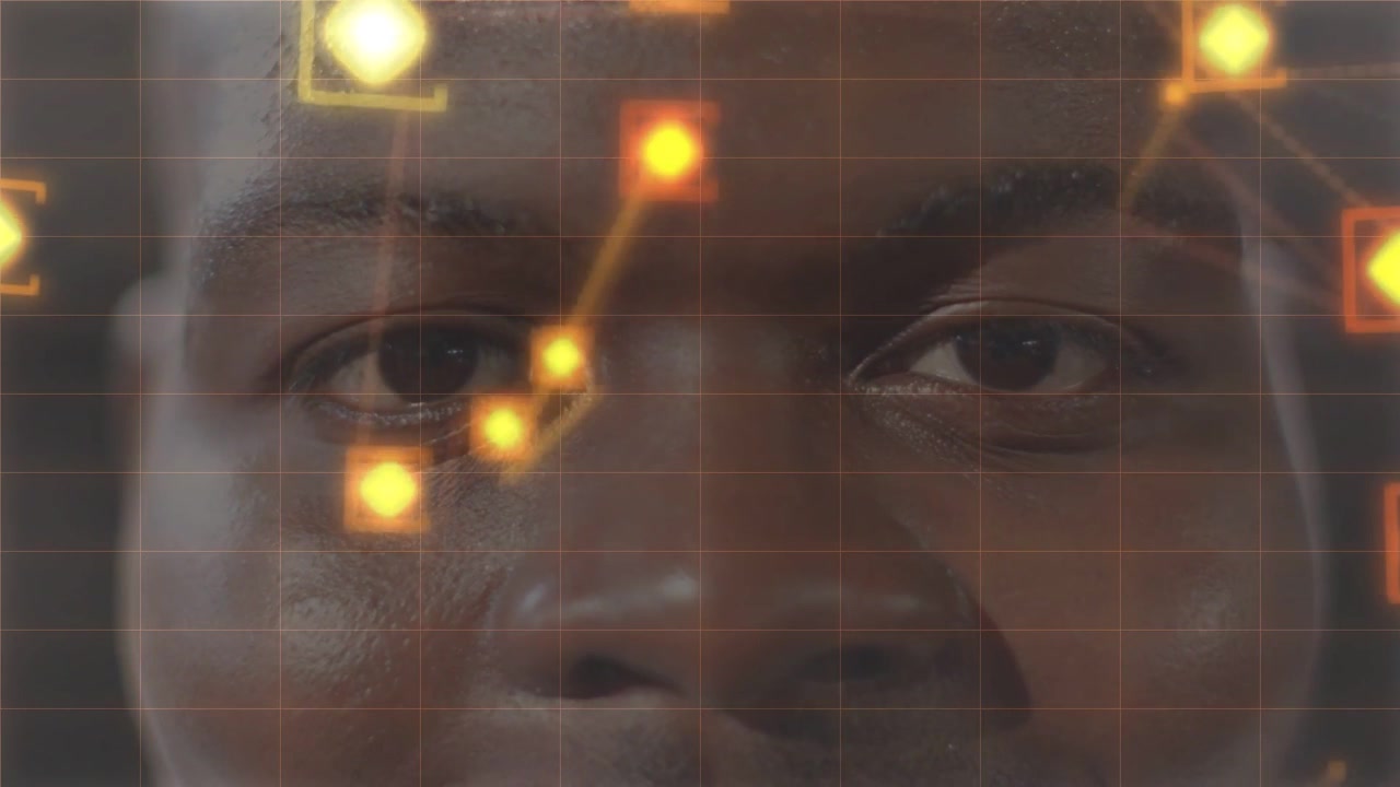 Vertical video: Showing grid, man keeping gaze in studio while amber streaks and nodes forming net