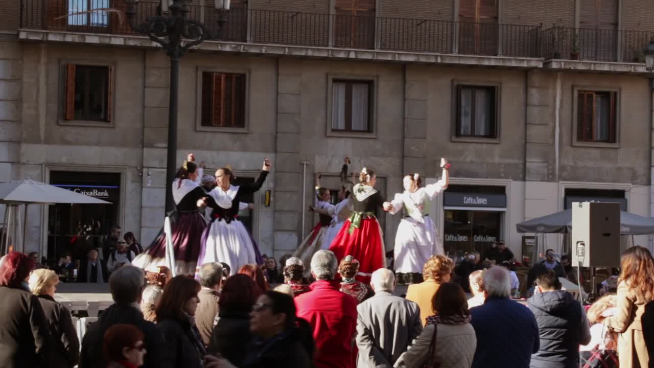 Spanish women dancing in spain at a festival in valencian square on warm sunny day