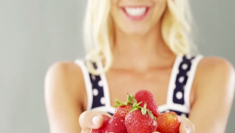 close-up of woman holding strawberries