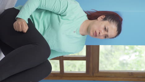 Vertical-video-of-The-woman-who-punches-the-wall-in-anger.