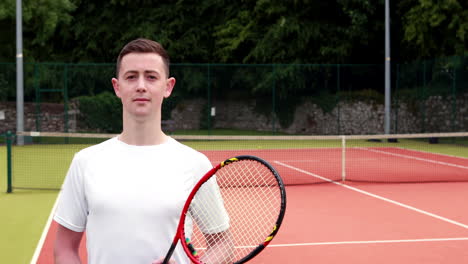 Young-tennis-player-smiling-at-camera