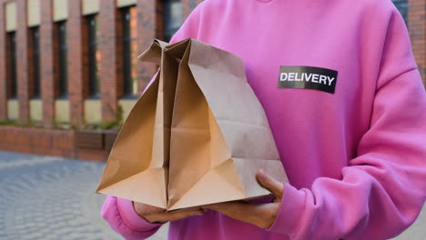 Young-woman-holding-paper-bags-on-the-street