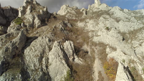 Mountain-ridge-footage-from-a-descending-drone,-captured-from-a-narrow-perspective-looking-up