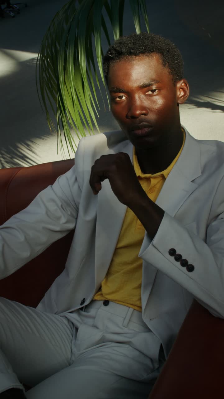 Stylish man sitting on a couch | Premium Stock Video Footage