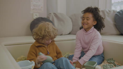 little kids with wooden cubes