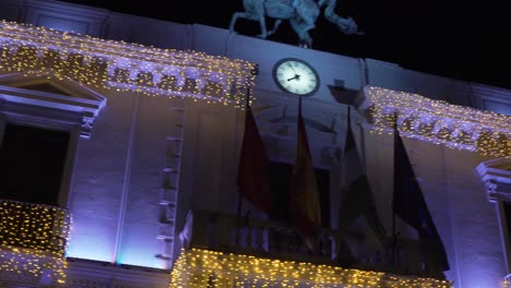 christmas gold string mini-lights beautifully brighten the building facade - pan up shot