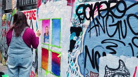 artist painting graffiti on hosier lane wall