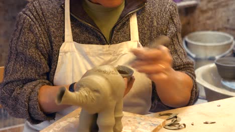 potter working on clay sculpture