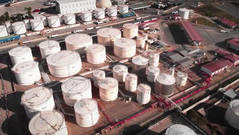 gas tanks with pipelines at refinery complex. oil storage tanks in port. huge white gas and fuel tanks at oil refinery. plant with gas tanks and refinery equipment. manufacturing and production