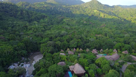 cabin cottage resort in the middle of the lush tropical jungle at sunset