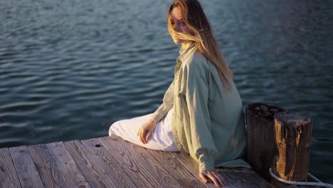 close up footage of a happy girl sitting on a wooden pier