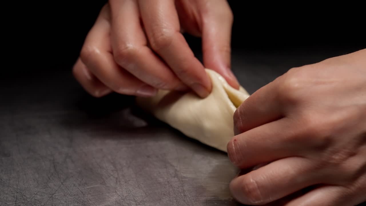 Close-Up of Hands Preparing and Folding Dough with Filling
