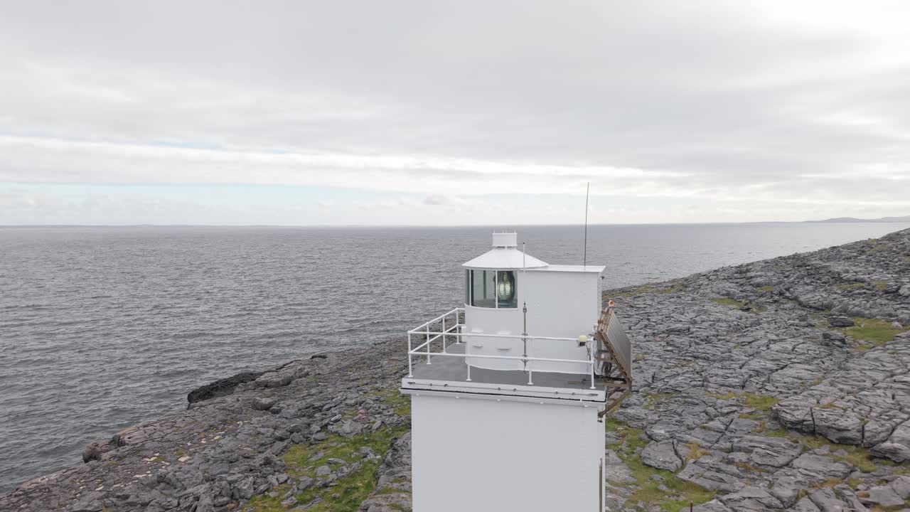 Black Head Lighthouse standing on rocky terrain with views of the ocean in County Clare, Ireland