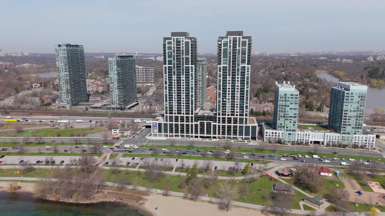 Aerial push-in of Mirabella Towers, shore and road traffic in Toronto