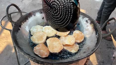 preparing dal puri in a road side stall in india.