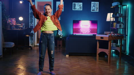 Cute-girl-in-neon-lit-apartment-filming-dance-tutorial-for-other-children-watching-her