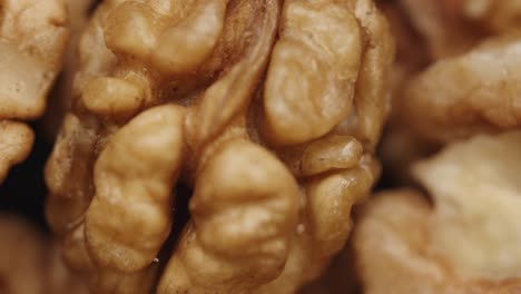 smooth camera movement over a handful walnuts.