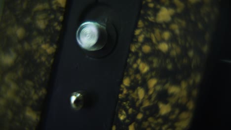 macro shot of a tripod plate close up, camera gear, silver screw, smooth tilt up crane movement, 120fps slow motion, full hd