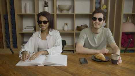 blind friends sitting at the table