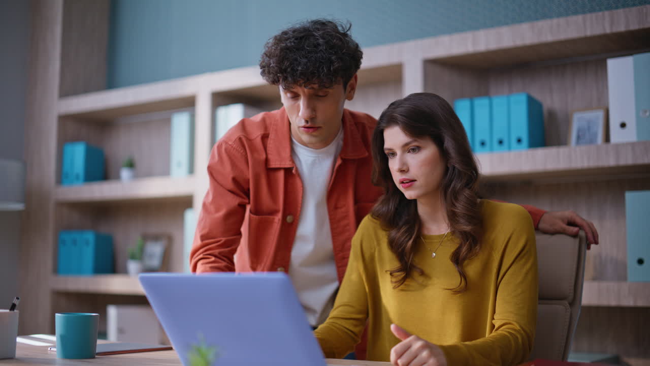 Concerned coworkers talking video call discussing problem in office closeup