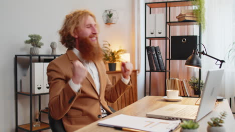 business man working on laptop shocked by sudden victory game winning lottery good career news mail