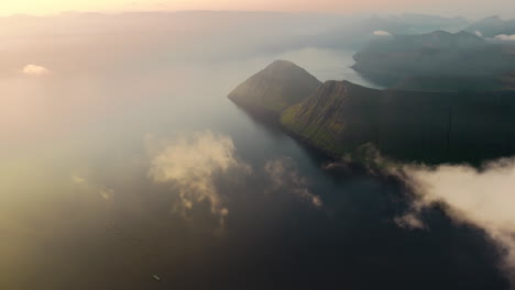 Aerial View of Misty Coastal Mountains and Fjord with Aquaculture at Sunrise or Sunset