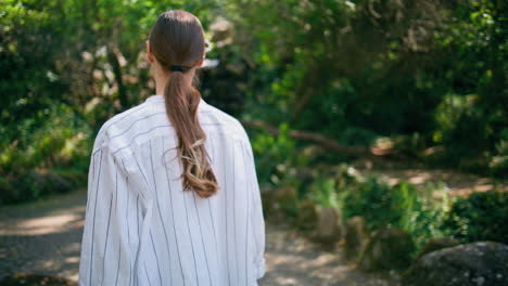 serene traveler walking nature looking greenery close up. woman relaxing park