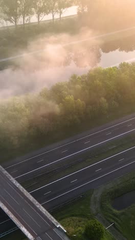 highway crossing in foggy sunrise