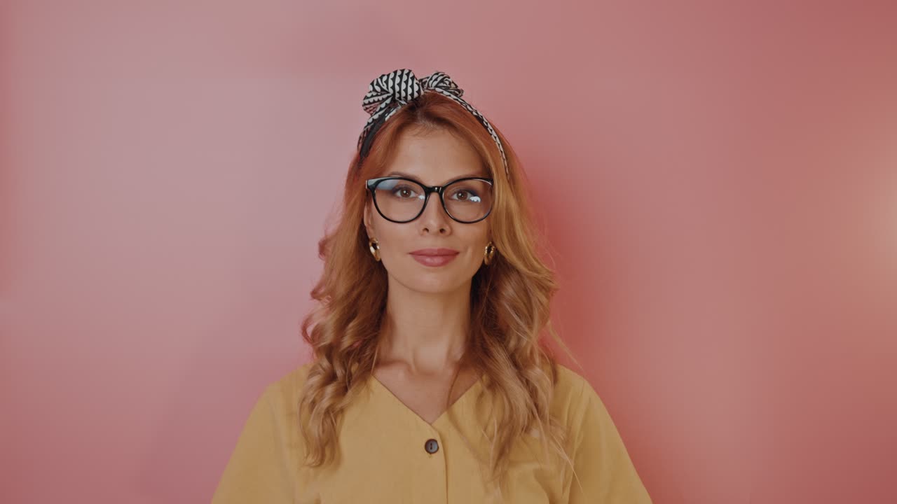 Woman with Glasses and Headband in a Yellow Shirt