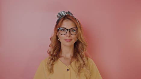 woman with glasses and headband in a yellow shirt