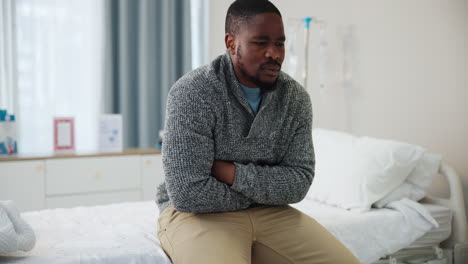 man in pain in hospital bed