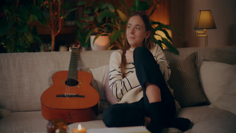 woman playing guitar writing song composing music