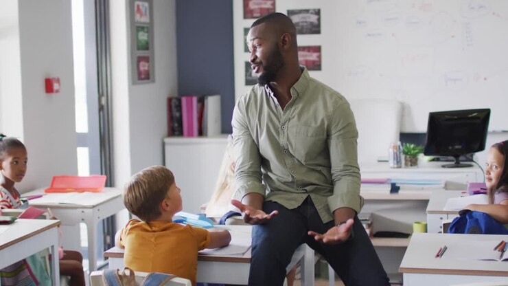 Video of happy african american male teacher during lesson with class of diverse pupils