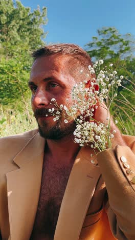 man with flowers in a beige coat